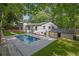 Large backyard with swimming pool, surrounding landscaping, and detached garage at 2858 Mornington Nw Dr, Atlanta, GA 30327