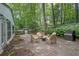 Inviting backyard featuring a stone patio, fire pit, and an outdoor kitchen for relaxed entertaining at 2858 Mornington Nw Dr, Atlanta, GA 30327