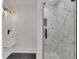 Modern bathroom with a stylish vanity, decorative lights, and a sleek glass-enclosed shower with marble-like tiling at 2858 Mornington Nw Dr, Atlanta, GA 30327