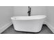 Elegant bathroom showcasing a modern freestanding tub and sleek black fixtures against a minimalist backdrop at 2858 Mornington Nw Dr, Atlanta, GA 30327