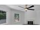 Bright bedroom with a modern ceiling fan and marble fireplace, illuminated by two large windows at 2858 Mornington Nw Dr, Atlanta, GA 30327