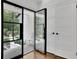 Open doorway showcasing a modern glass door, white trim, and hardwood floors at 2858 Mornington Nw Dr, Atlanta, GA 30327