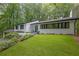 Beautiful home exterior with well-maintained lawn, dark trim, and lush landscaping at 2858 Mornington Nw Dr, Atlanta, GA 30327