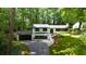 Charming two-story home with landscaped yard and dark trim surrounded by mature trees at 2858 Mornington Nw Dr, Atlanta, GA 30327