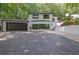 Striking exterior featuring a two-story home with dark trim and an attached garage at 2858 Mornington Nw Dr, Atlanta, GA 30327