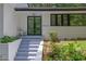 Stylish black-framed glass front door with lush greenery and modern white trim at 2858 Mornington Nw Dr, Atlanta, GA 30327