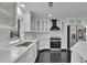 Modern kitchen with white cabinets, stainless steel appliances, granite countertops, and black tile floors at 2858 Mornington Nw Dr, Atlanta, GA 30327