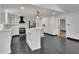 Spacious kitchen with white cabinets, island, stainless steel appliances, and contrasting black tile floors at 2858 Mornington Nw Dr, Atlanta, GA 30327