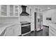 Bright kitchen with white cabinets, marble countertops, and stainless steel appliances at 2858 Mornington Nw Dr, Atlanta, GA 30327