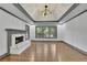 Bright living room featuring hardwood floors, a marble fireplace, recessed lighting, and large windows at 2858 Mornington Nw Dr, Atlanta, GA 30327