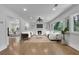 Staged living room featuring hardwood floors, fireplace, built-in shelving and large windows with backyard views at 2858 Mornington Nw Dr, Atlanta, GA 30327