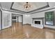 Spacious living room with fireplace, wood floors, and view of the pool at 2858 Mornington Nw Dr, Atlanta, GA 30327
