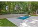 Beautiful backyard pool surrounded by lush greenery, trees and a concrete patio for outdoor relaxation at 2858 Mornington Nw Dr, Atlanta, GA 30327