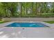 A pristine swimming pool surrounded by concrete and lush greenery is perfect for relaxing at 2858 Mornington Nw Dr, Atlanta, GA 30327