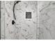 Close-up of a marble-tiled shower featuring black hardware and a convenient built-in niche at 2858 Mornington Nw Dr, Atlanta, GA 30327