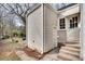 Backyard exterior of home with stairs leading up to a door and a well-maintained yard at 332 Shadowmoor Dr, Decatur, GA 30030