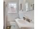 Bathroom featuring a white vanity, toilet, and shower/tub with a window for natural light at 332 Shadowmoor Dr, Decatur, GA 30030
