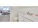 Bathroom with white vanity and fixtures, adjacent to a bedroom with a gray carpet at 332 Shadowmoor Dr, Decatur, GA 30030