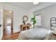 Bright bedroom boasts white walls, wood floors, and a cozy seating area with natural light at 332 Shadowmoor Dr, Decatur, GA 30030