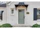 Close up of the light gray front door with black awning on a white brick home at 332 Shadowmoor Dr, Decatur, GA 30030