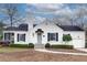 Charming white brick home with a gray door, a well-manicured lawn, and black shutters at 332 Shadowmoor Dr, Decatur, GA 30030