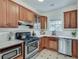 Well-lit kitchen featuring stainless steel appliances, white countertops, and wood cabinets at 332 Shadowmoor Dr, Decatur, GA 30030