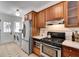 Well-equipped kitchen featuring stainless steel appliances and adjacent laundry area at 332 Shadowmoor Dr, Decatur, GA 30030