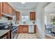 Bright kitchen with stainless steel appliances, wood cabinets, and view to dining area at 332 Shadowmoor Dr, Decatur, GA 30030