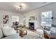 Living room with a fireplace, hardwood floors, and a gray accent chair at 332 Shadowmoor Dr, Decatur, GA 30030