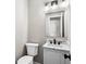 Powder room featuring modern fixtures, marble countertop, and stylish lighting at 3589 Hopkins Ct, Powder Springs, GA 30127