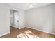 Bedroom featuring natural light, fresh paint, modern light fixture, and wood-look flooring at 3589 Hopkins Ct, Powder Springs, GA 30127