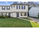 Charming townhome with tidy lawn, sidewalk, and traditional architectural details at 3589 Hopkins Ct, Powder Springs, GA 30127