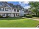 Attractive townhome showcasing a lush green lawn and a paved driveway at 3589 Hopkins Ct, Powder Springs, GA 30127