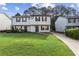 Inviting two-story townhome featuring a well-manicured lawn and a private driveway at 3589 Hopkins Ct, Powder Springs, GA 30127