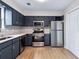 Kitchen with stainless steel appliances, updated cabinets, tile backsplash, and new flooring at 3589 Hopkins Ct, Powder Springs, GA 30127