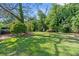 The expansive backyard offers mature trees, lush green grass, and plenty of space for outdoor activities and entertaining at 1643 Flintwood Se Dr, Atlanta, GA 30316