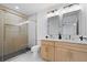 Modern bathroom with glass shower, double vanity, and contemporary fixtures at 1643 Flintwood Se Dr, Atlanta, GA 30316
