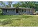 Charming single-story home with a well-maintained lawn, mature trees, and a newly painted exterior at 1643 Flintwood Se Dr, Atlanta, GA 30316
