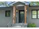 Inviting front porch with black railings, wood pillars, and stylish lighting at 1643 Flintwood Se Dr, Atlanta, GA 30316
