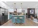 Open-concept kitchen with white cabinets, blue island, and stainless appliances at 1643 Flintwood Se Dr, Atlanta, GA 30316