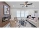 Cozy living room with fireplace, modern fan, and neutral decor at 1643 Flintwood Se Dr, Atlanta, GA 30316