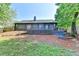 Back exterior view featuring gray siding, deck and landscaped yard at 2190 Ashley Crossing Ct, Lawrenceville, GA 30043
