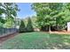 A well-maintained backyard featuring lush greenery and privacy fence at 2190 Ashley Crossing Ct, Lawrenceville, GA 30043