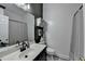 Bathroom featuring a vanity, mirror, toilet, shower, and decorative greenery at 2190 Ashley Crossing Ct, Lawrenceville, GA 30043