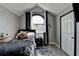 Cozy bedroom featuring a unique arched window, gray walls, and wood-look flooring at 2190 Ashley Crossing Ct, Lawrenceville, GA 30043