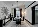 Dining room features white table, black chairs, modern chandelier, and decorative wall art at 2190 Ashley Crossing Ct, Lawrenceville, GA 30043