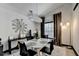 Bright dining room with modern light fixture, white table, black chairs, and artistic decor at 2190 Ashley Crossing Ct, Lawrenceville, GA 30043