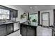 Well-lit kitchen features stainless steel appliances, granite counters, and backyard views at 2190 Ashley Crossing Ct, Lawrenceville, GA 30043
