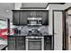 Close up view of a gas range and mosaic tile backsplash at 2190 Ashley Crossing Ct, Lawrenceville, GA 30043