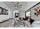 Open-concept living room featuring stylish decor, a modern fan, and seamless flow into other areas at 2190 Ashley Crossing Ct, Lawrenceville, GA 30043